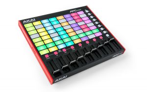 Product photo of the The Akai Professional APC Mini MIDI ontroller featuring a grid of multicolored, backlit pads centrally located, accompanied by eight black sliders with corresponding buttons situated below. The device boasts a sleek rectangular design, highlighted by a red border and a black surface.