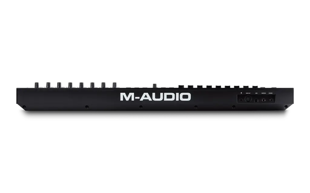 The rear view of an M-AUDIO Oxygen 49 Pro keyboard controller reveals multiple control knobs alongside connections for power, USB, MIDI, and other ports. Prominently displayed in large white letters is the M-AUDIO logo, clearly indicating the brand.